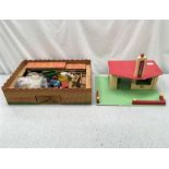 A Fisher Price parking ramp and service center along with a toy wooden petrol station and a Wild