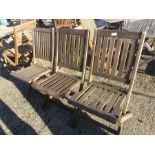 A set of three garden folding chairs.