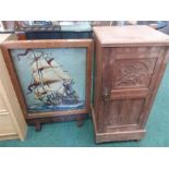A mahogany pot cupboard together with an oak firescreen tapestry of a sailing ship.