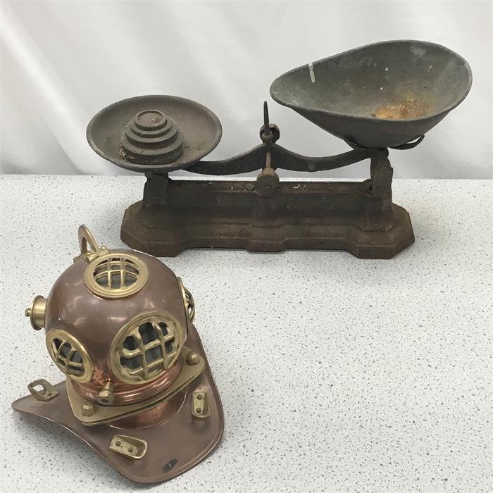 A set of scales and an ornamental diver’s helmet.
