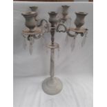 A painted metal five holder candelabra with glass droplets.