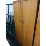 A teak double wardrobe by Leybus.