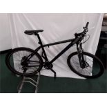 A Carrera mountain bike. 27 speed with front suspension and hydraulic disc brakes. A few signs of
