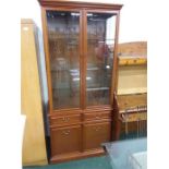 A modern china display cabinet with etched glass doors and cupboard under.