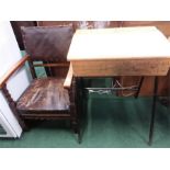 A lift top school desk together with an oak armchair.