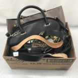 A box containing handbags, sunglasses and other clothing apparel.