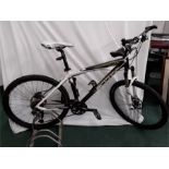 A Scott mountain bike. 27 speed with front suspension, hydraulic disc brakes, a pump and rear light.