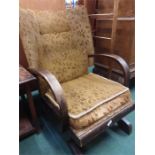 An oak upholstered rocking chair.