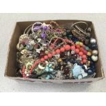 A box of costume jewellery, including bracelets and necklaces.