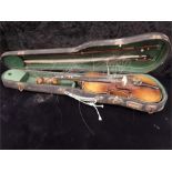 An antique violin in case with two bows.