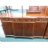 A yew wood breakfront sideboard.