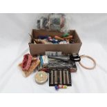 A box of sewing items to include needles crochet hook, thimbles, cottonseed and a Handy guide for