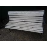 A garden bench with wooden slats.