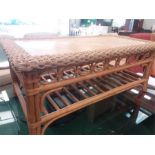 A bamboo two tier coffee table with roped edging.