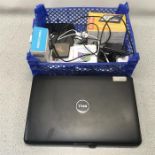 A Dell Inspiron laptop computer along with a collection of cameras, mobile phones and a satnav.