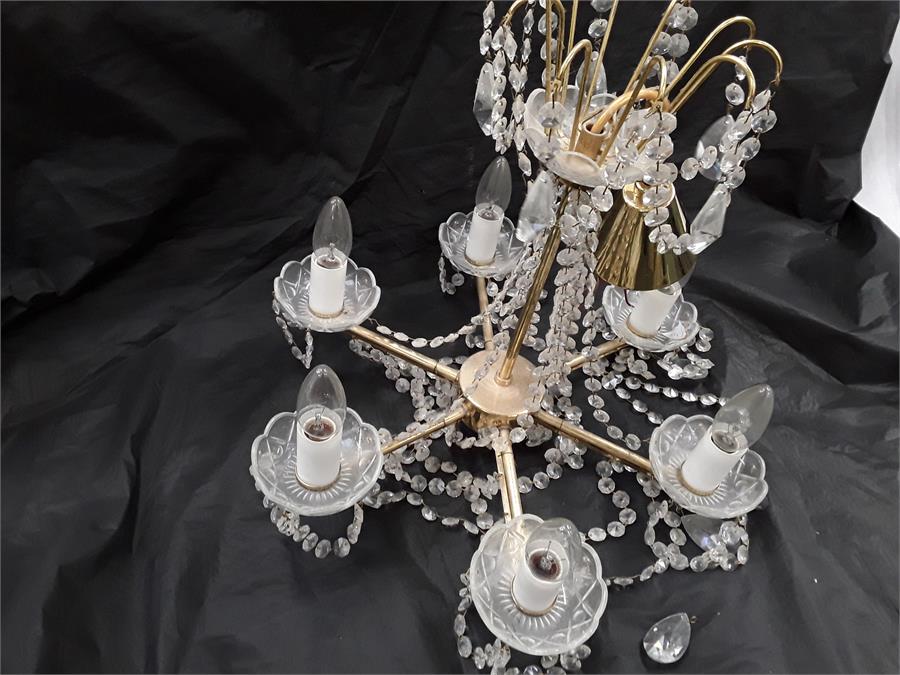 A brass six branch chandelier with cut glass droplets and six glass cups. - Image 2 of 2