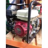 A Honda GX120 4.0 powered petrol water pump with hose.