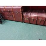 Two wood bound travel trunks.