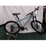A Raleigh mountain bike. 24 speed with front suspension and mechanical disc brakes. Light rust to
