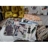 Two boxes of vintage material to include linen and 70's style together with a quantity of knitting