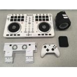 A Numark mixing deck with other game and musical items.