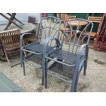 A set of four stacking garden chairs with full seat cushions.