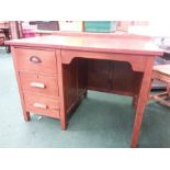An oak kneehole desk.