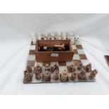 An onyx chess set together with wooden boxed chess pieces.