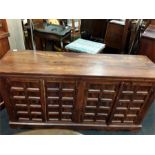 A large Indian sideboard with two cupboards. with square paneled doors