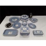 A quantity of Wedgwood to include a lighter, pin trays and trinket boxes in blue slip.