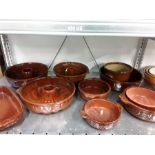 A quantity of oven ware in brown glaze.