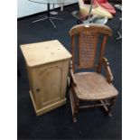 A pine bedside table together with a wicker/oak rocking chair.