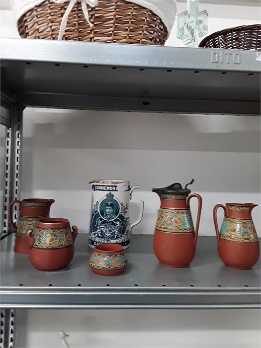 A quantity of Prattware terracotta pottery decorated with bands of flowers etc.