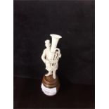 A late 19th century ivory study of a street musician. standing on a barrel