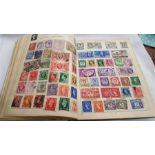 A box containing a large amount of world stamps.