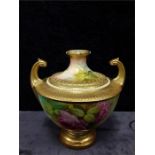 A Royal Worcester buff and gold gilt highlights china vase decorated with a rose. and two handles