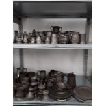 Two shelves of various pewter. to include plates, jugs, casters, etc.