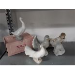 Three Nao figures together with a Lladro Polar bear and one other.