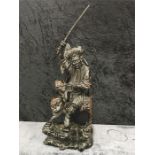 A carved Chinese Rootwood/hardwood sculpture of a fisherman.