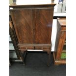 A reproduction flame verneered mahogany cocktail cabinet fitted 2 draws. On square legs maple