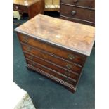 A small reproduction mahogany chest of four drawers.
