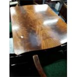 A reproduction extending mahogany dining table. (No chairs included).