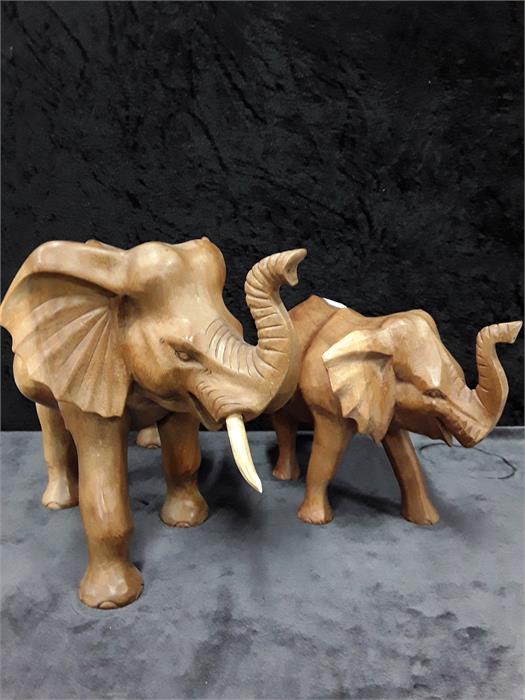 Two wooden carved elephants.