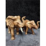 Two wooden carved elephants.