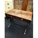 A mahogany reproduction sofa table with two drawers and side flaps.