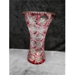 A large cranberry cut glass and star cut base patterned vase.