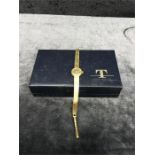 A ladies gold Tissot watch with box.