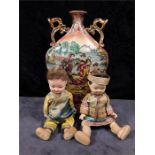 A Japanese china vase together with two small Japanese dolls in native dress .