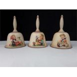 Three Goebel hummel bells decorated with children.