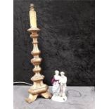 A carved florentine gilt wooden lamp base together with a German china figurine of a couple used for